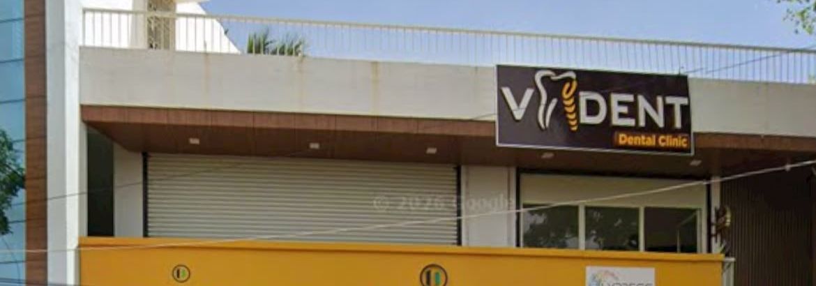 Building on Wireless Road with the V Dent Dental Clinic sign on the first floor