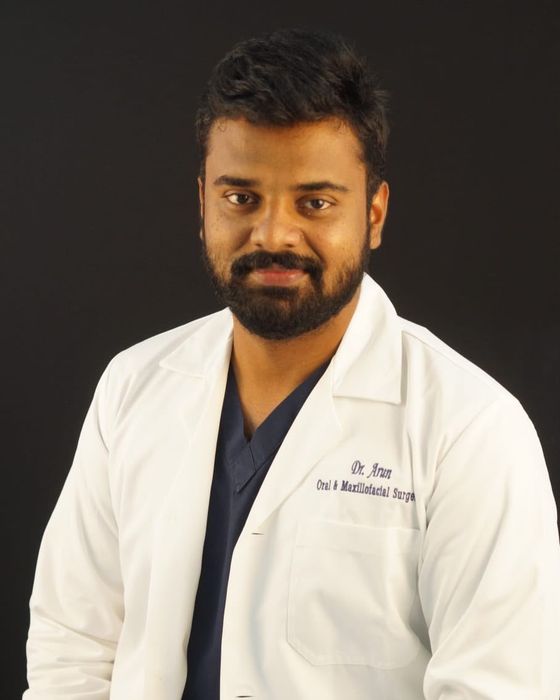 Portrait of Dr. Arun M in a white coat