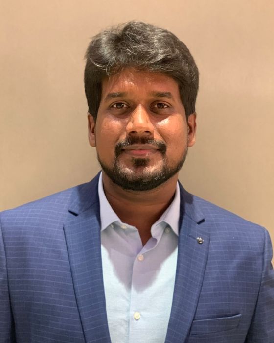 Portrait of Dr. Gopinath Kandhan in a blue blazer