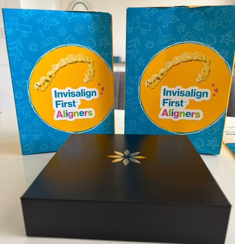 Invisalign First aligner boxes and an Invisalign case on a table at the clinic