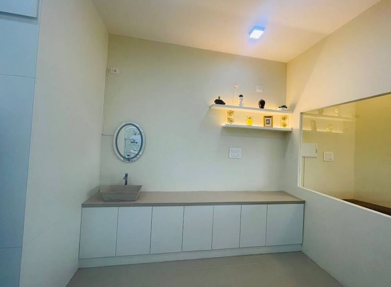 Treatment room counter with wash basin and lit shelves